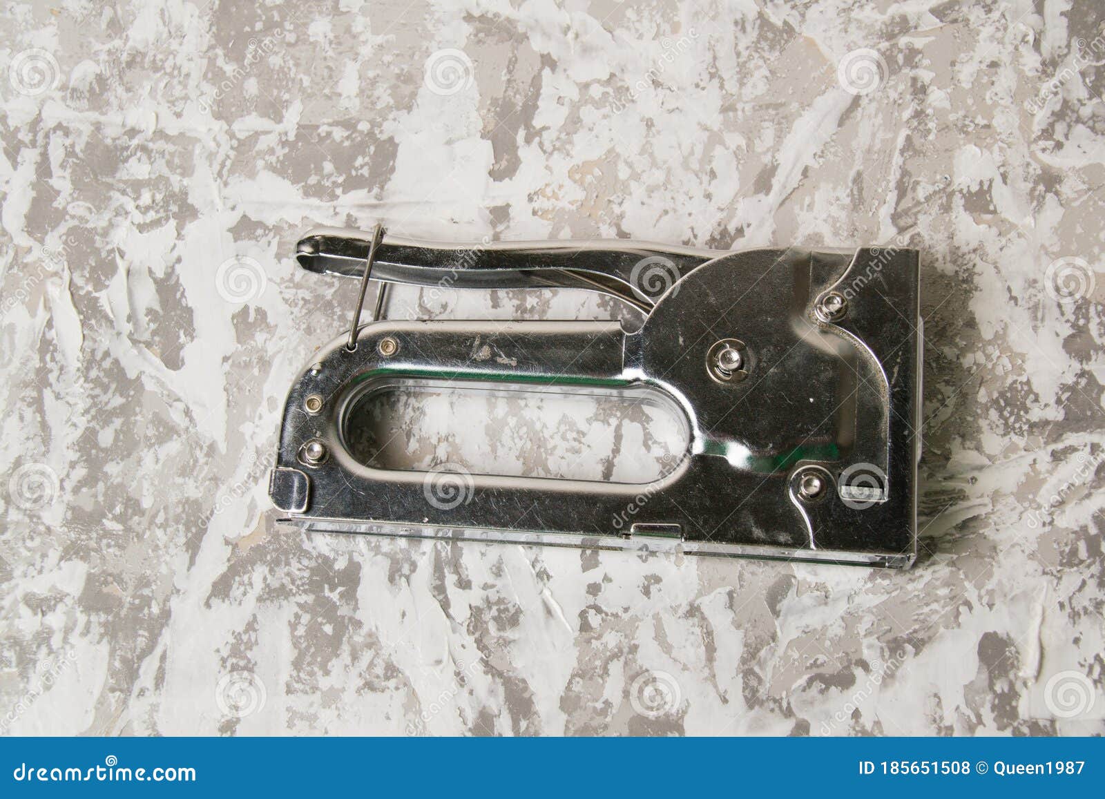 The Concept of Repair and Construction. Construction Stapler with Staples on a Background of