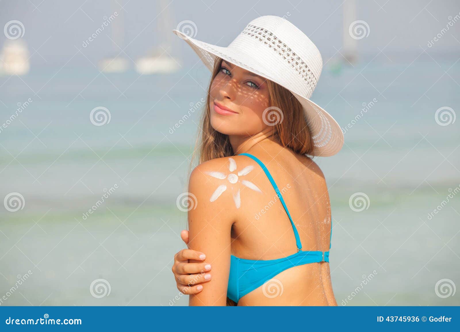 concept for safe sunbathing, woman with sun cream