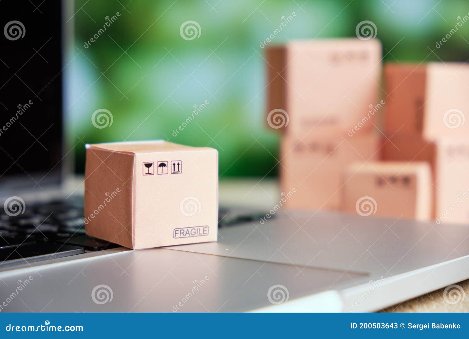 Concept of Sending and Tracking Cargo Online by Box on a Laptop Stock