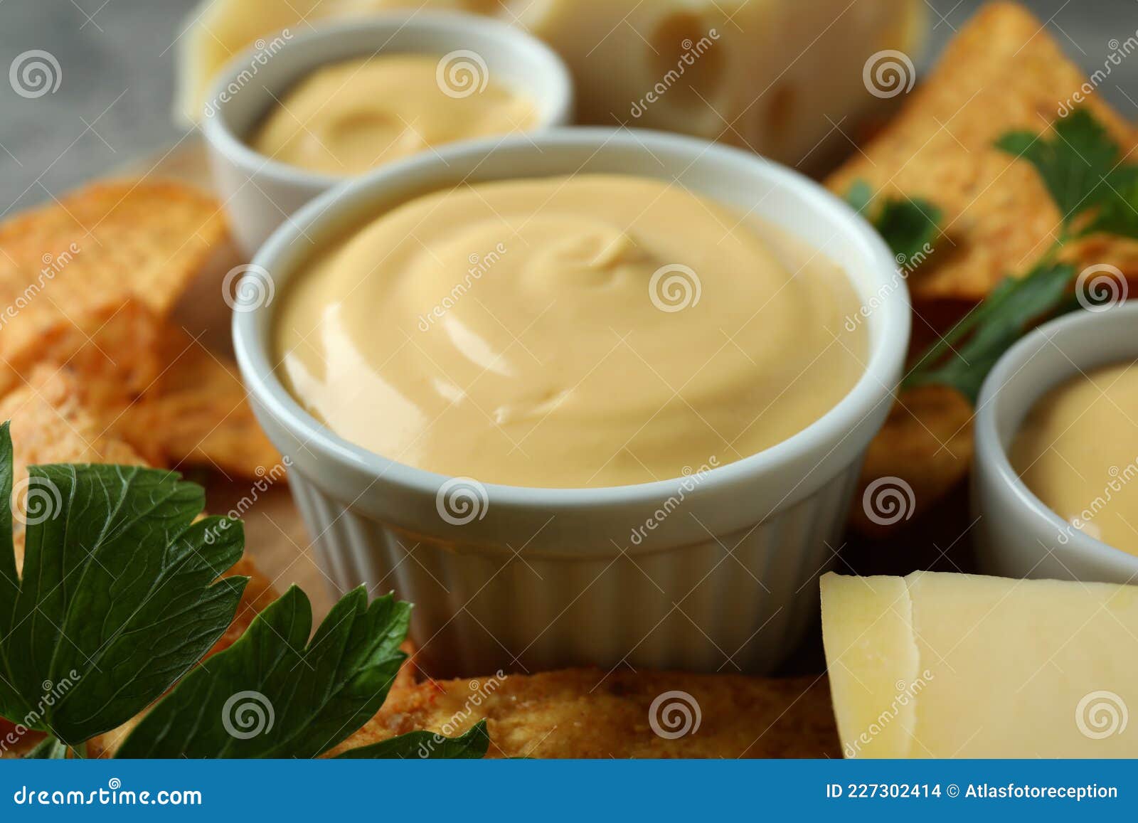 Concept of Snack with Chips and Cheese Sauce, Close Up Stock Photo