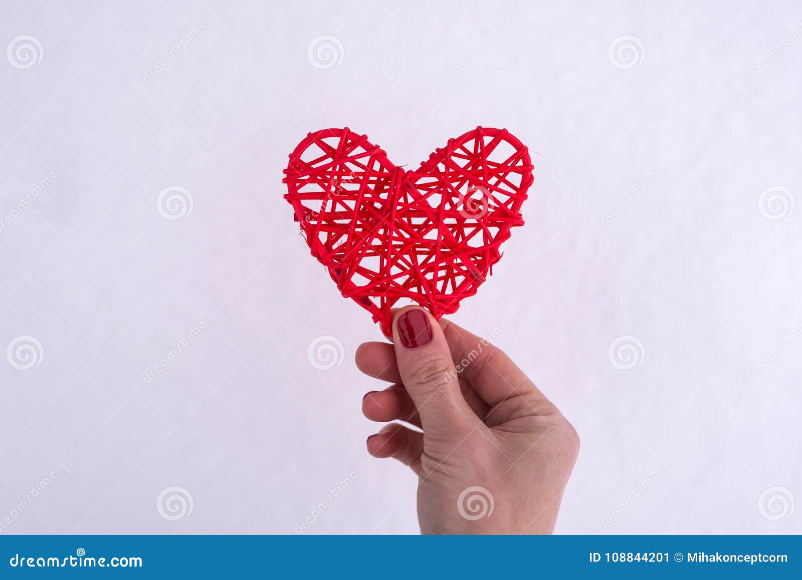 Concepto para Valentine& x27; día de s, casandose: mano que lleva a cabo un corazón rojo. Fondo romántico para las tarjetas