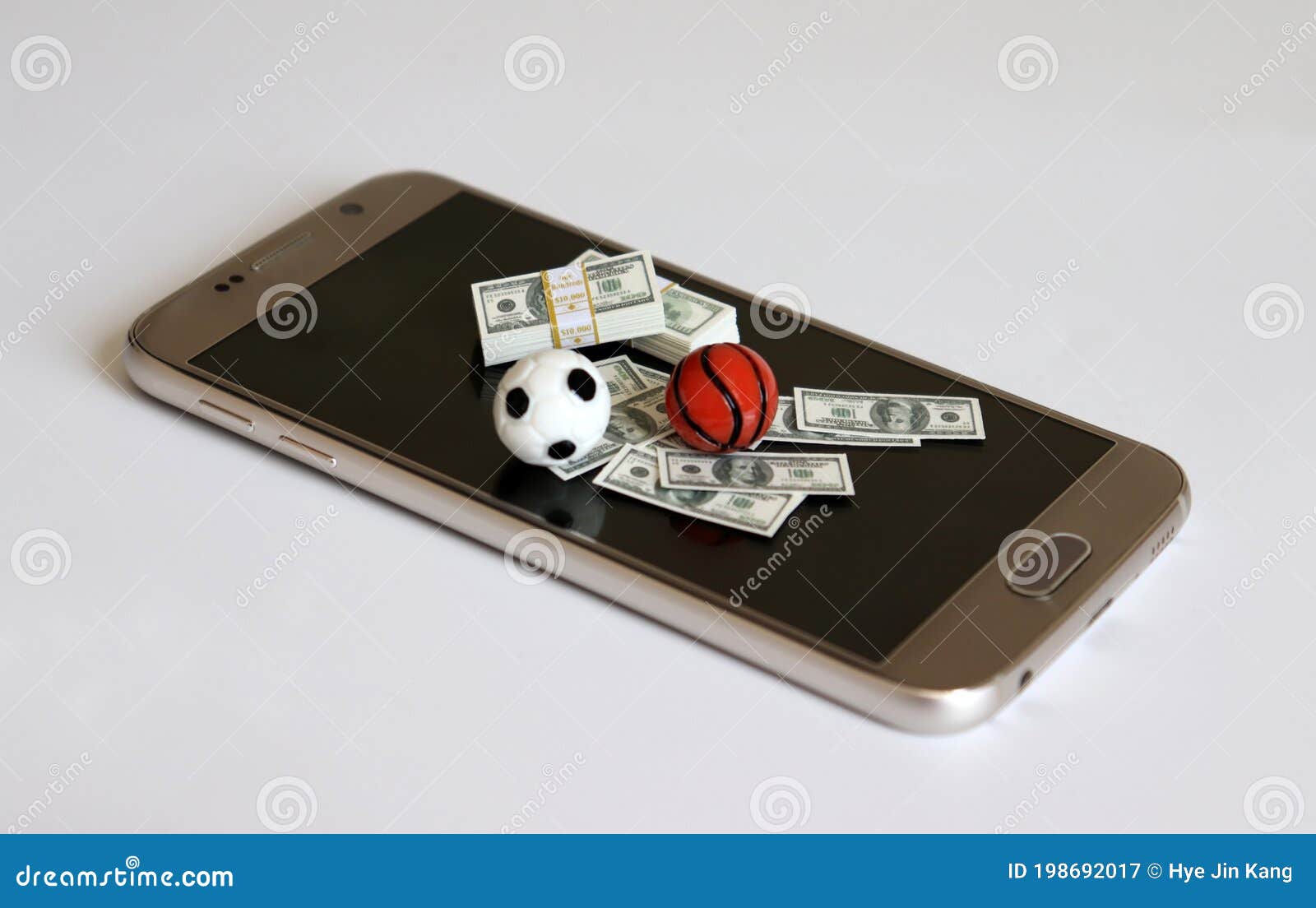  about online sports betting. the sports balls and money on the smartphone screen.