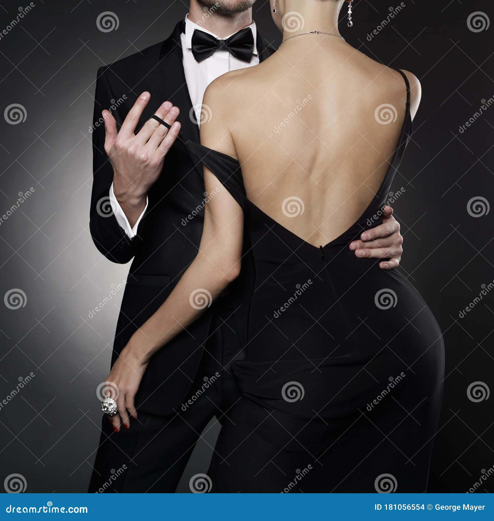 conceptual photo of sexy elegant couple in the evening suit and dress