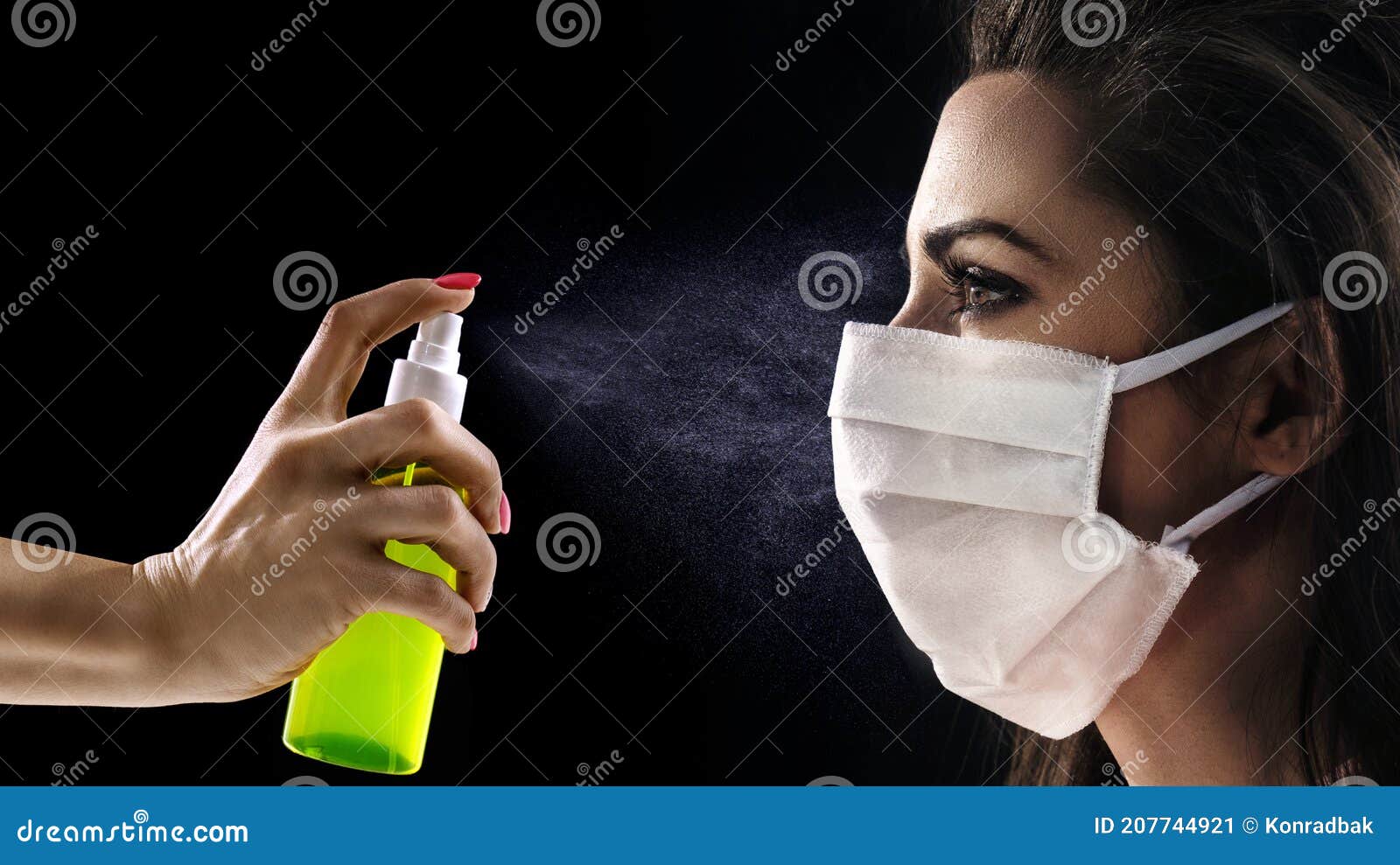 conceptual portrait of a woman wearing hygienic mask and looking at the antibacterial spray