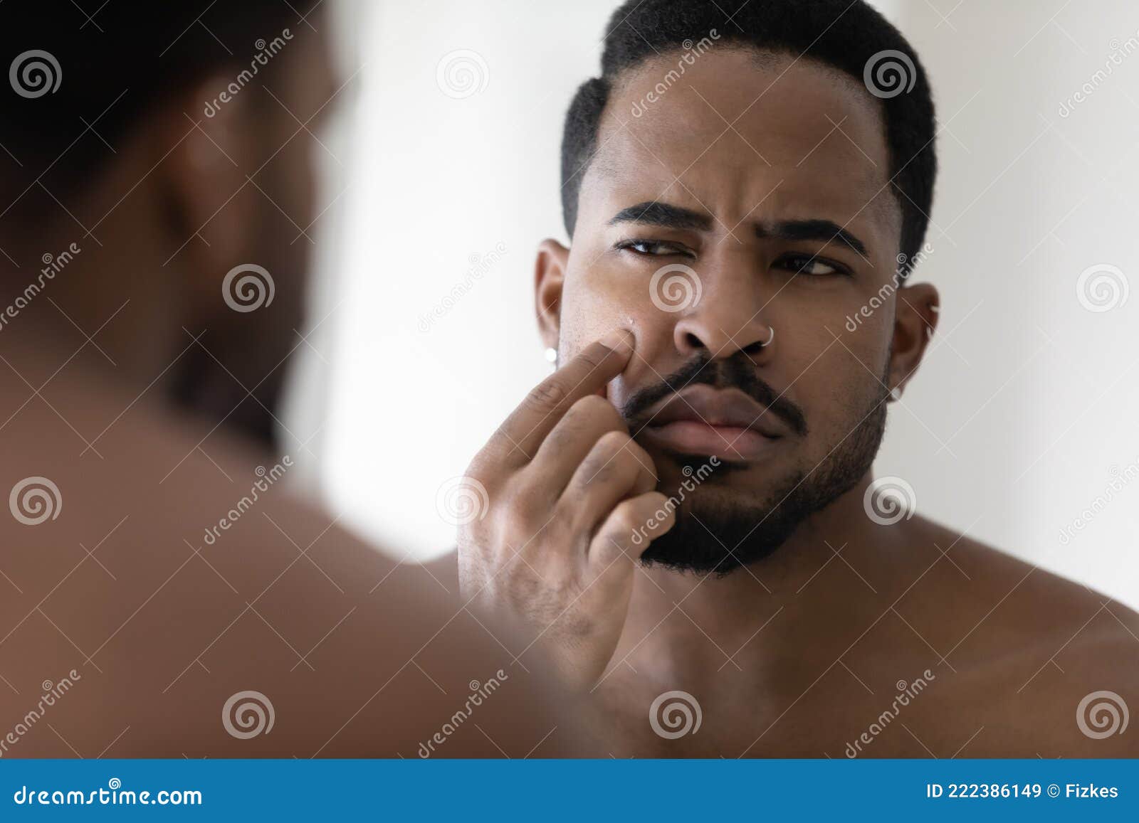 concerned metrosexual young black guy with stylish beard