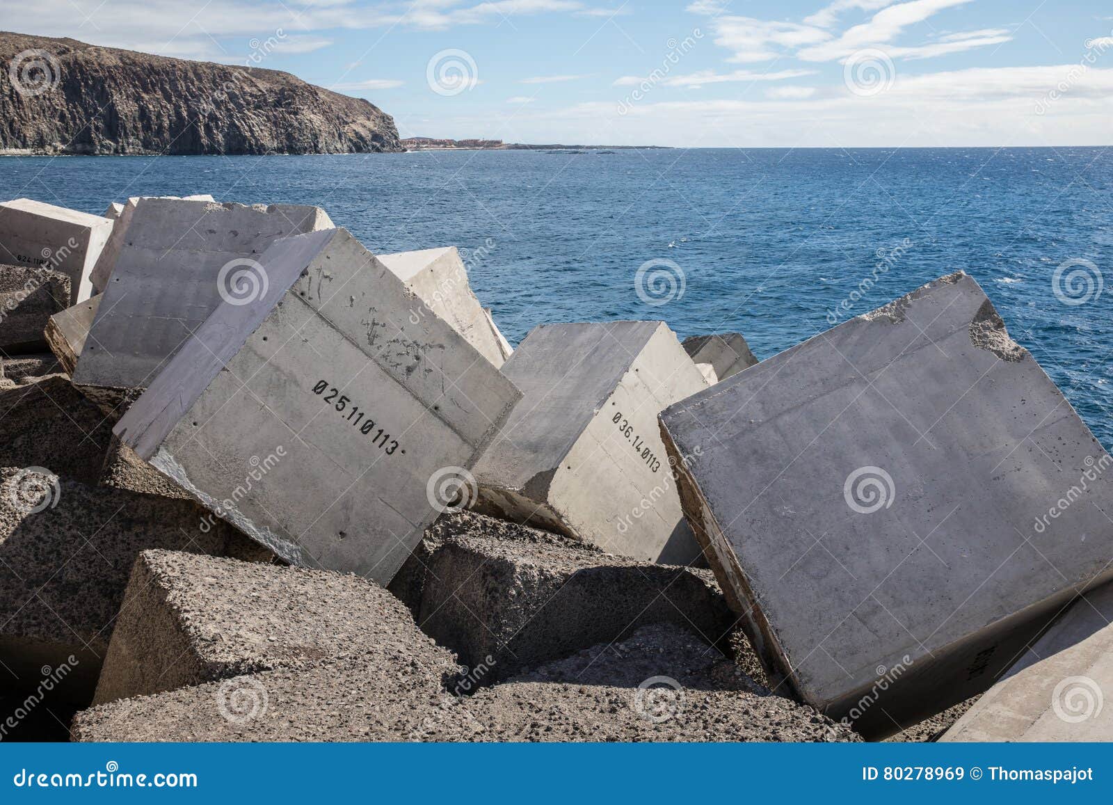 concrete blocks numbered in the jetty of los cristiano