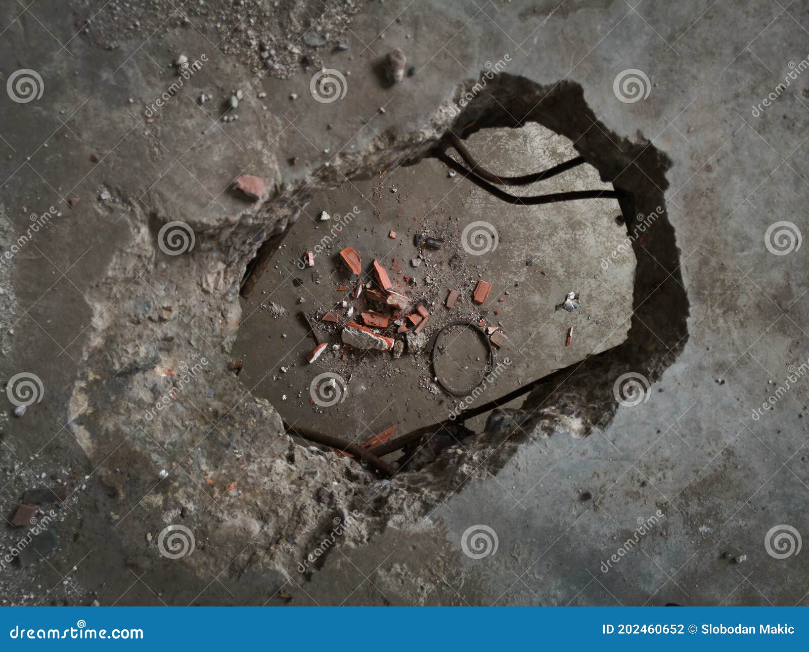 Concrete Construction, Hole in the Floor, Broken Bricks and Concrete Debris on the Floor Below
