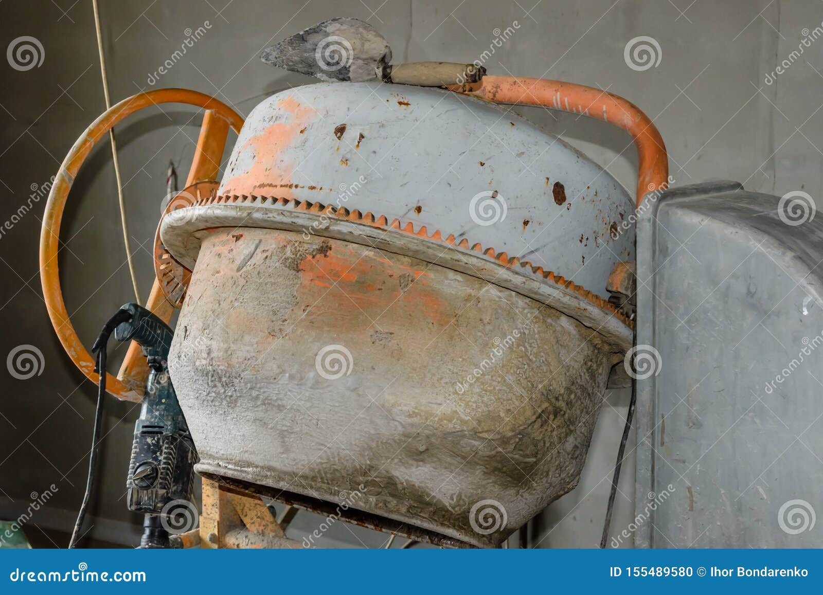 Concrete Mixer and Hammer Drill at the Construction Site Stock Photo