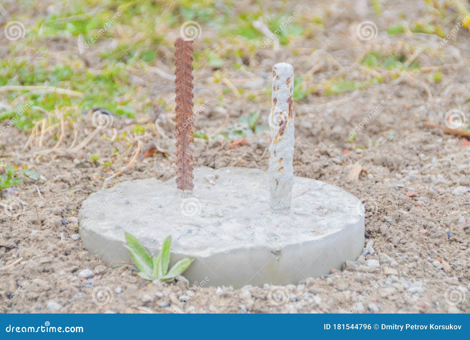 Concrete Post with Rebar for Building a House is Driven into the Ground