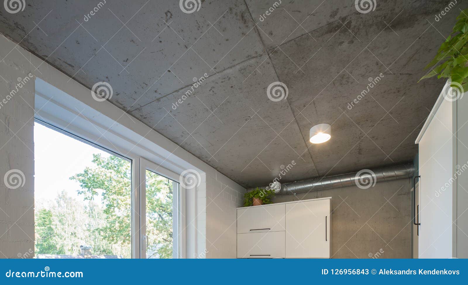 Concrete Ceiling And Lighting In A Modern Apartment