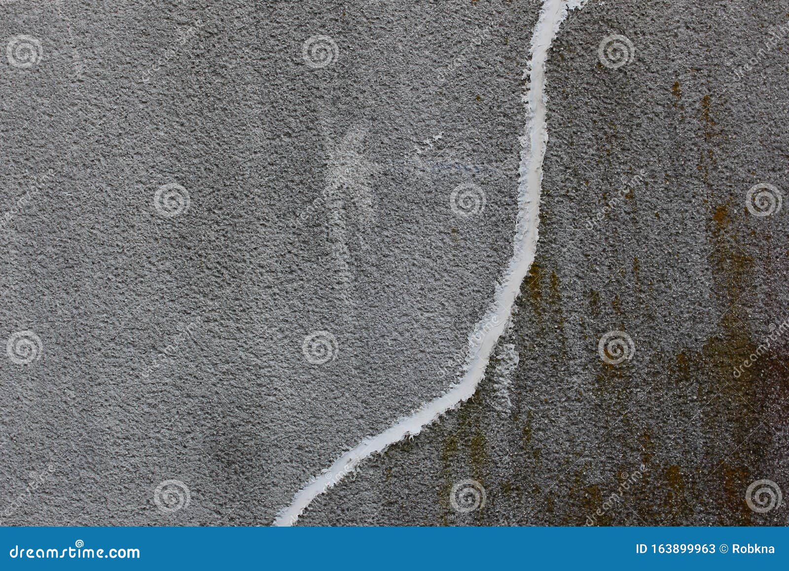 Concrete Wall with Crack Repaired with White Concrete Patching Putty