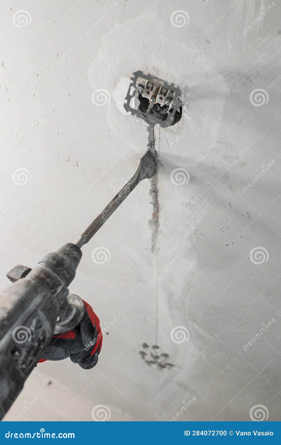 Concrete Wall Cutting and Concealed Wiring during Electrical Work Stock