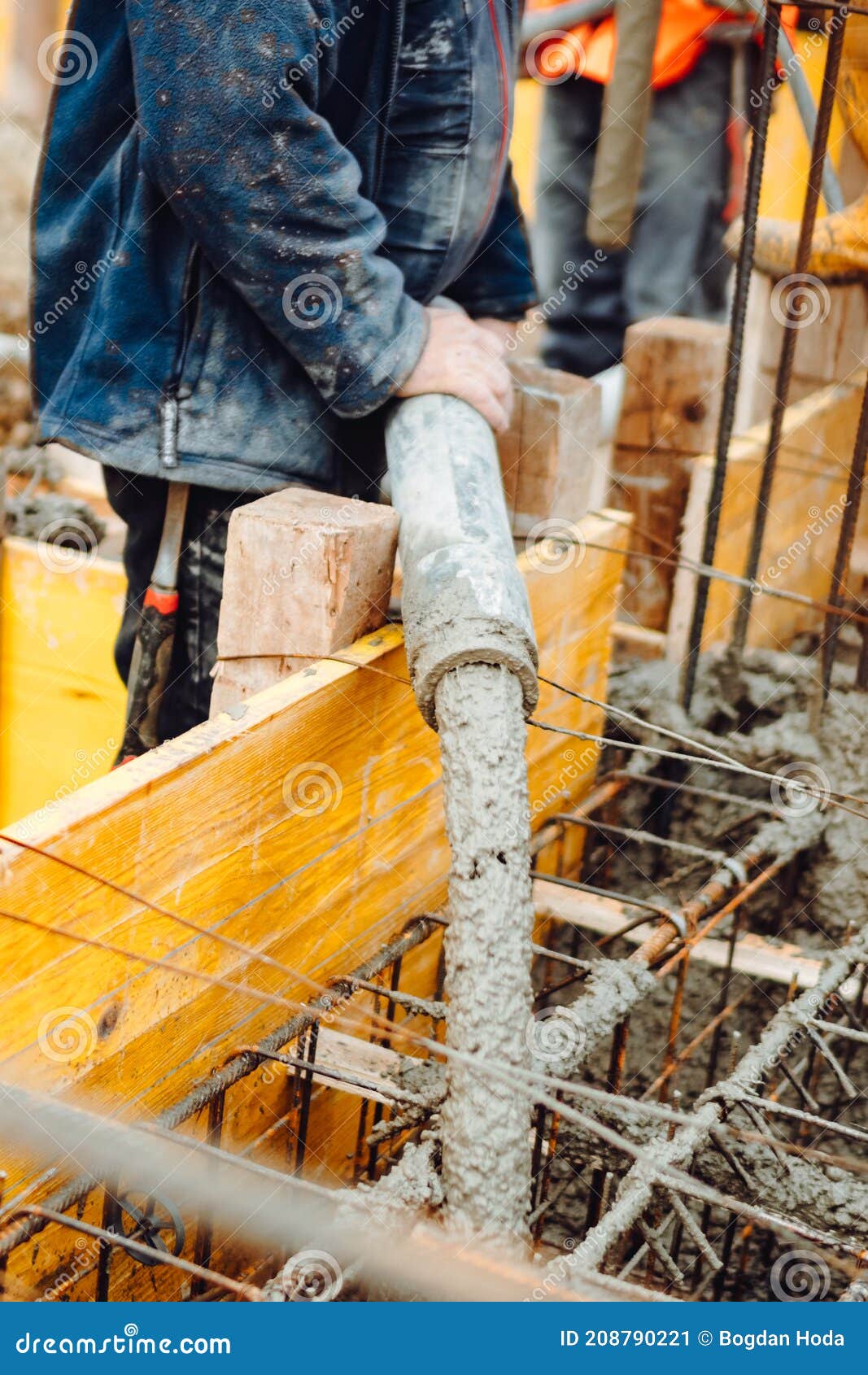 Works at the Construction Site. Construction Workers Pour Liquid Concrete from Cement Concrete