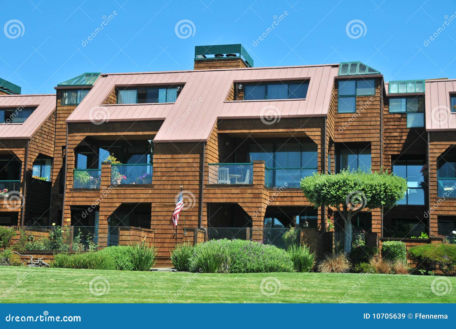 Condo building with grass stock image. Image of building 10705639