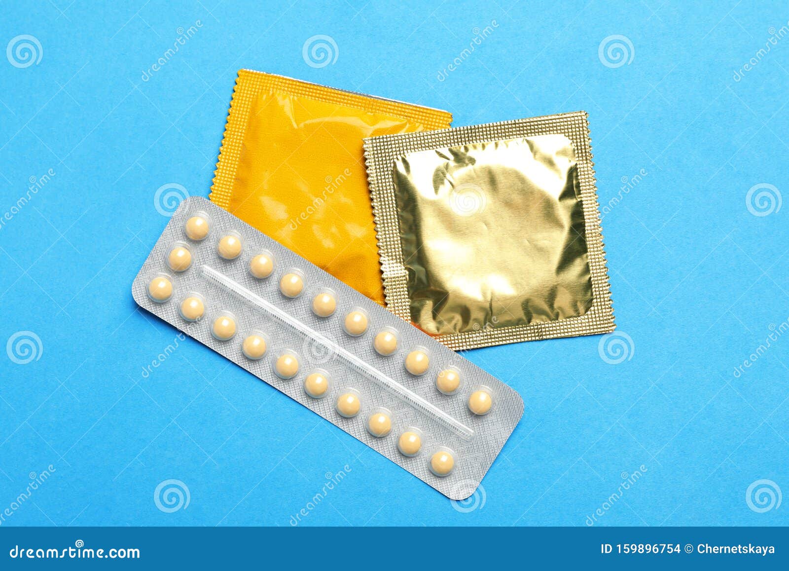 Condoms And Birth Control Pills On Light Blue Background Safe Sex