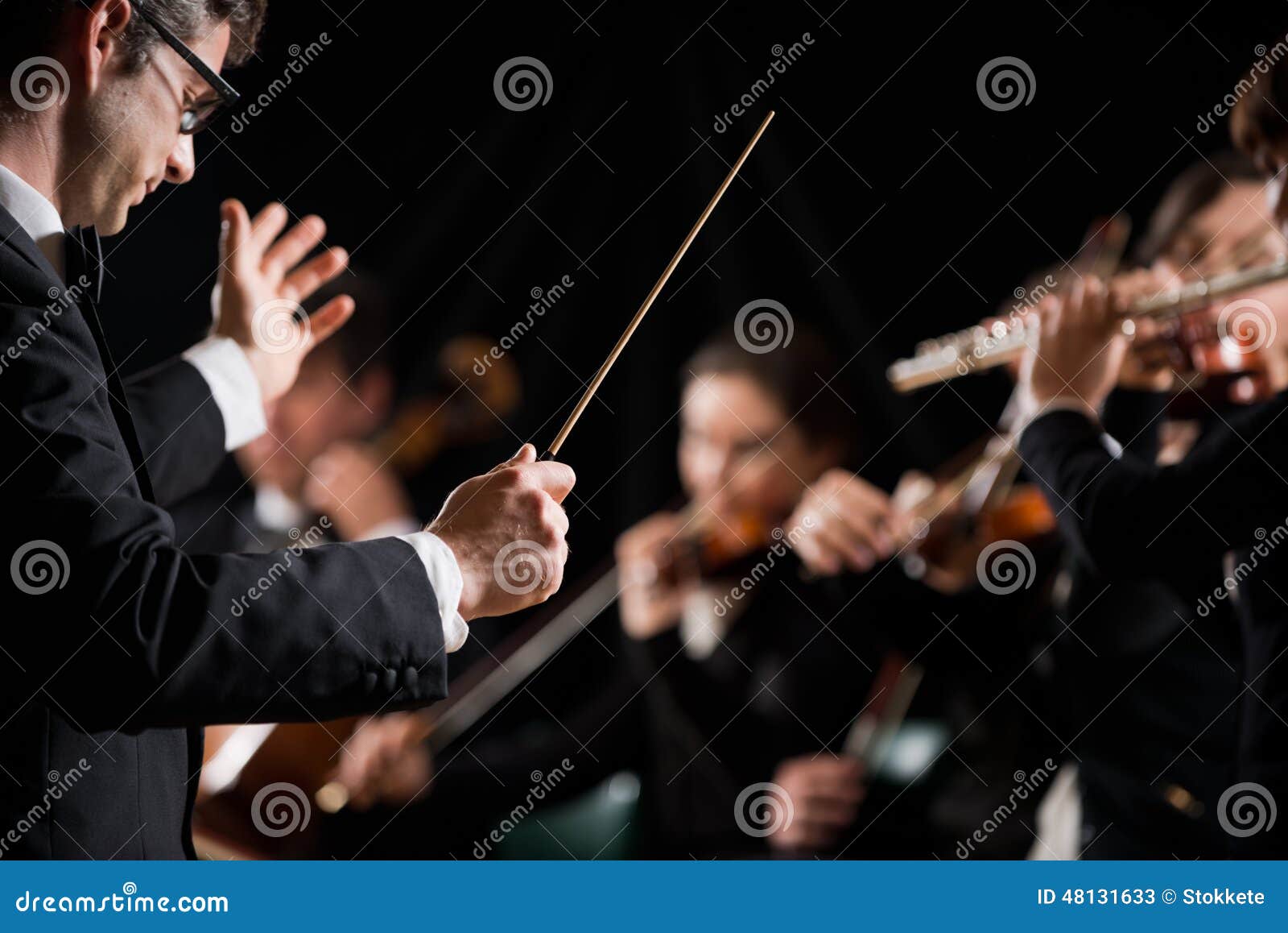 conductor directing symphony orchestra