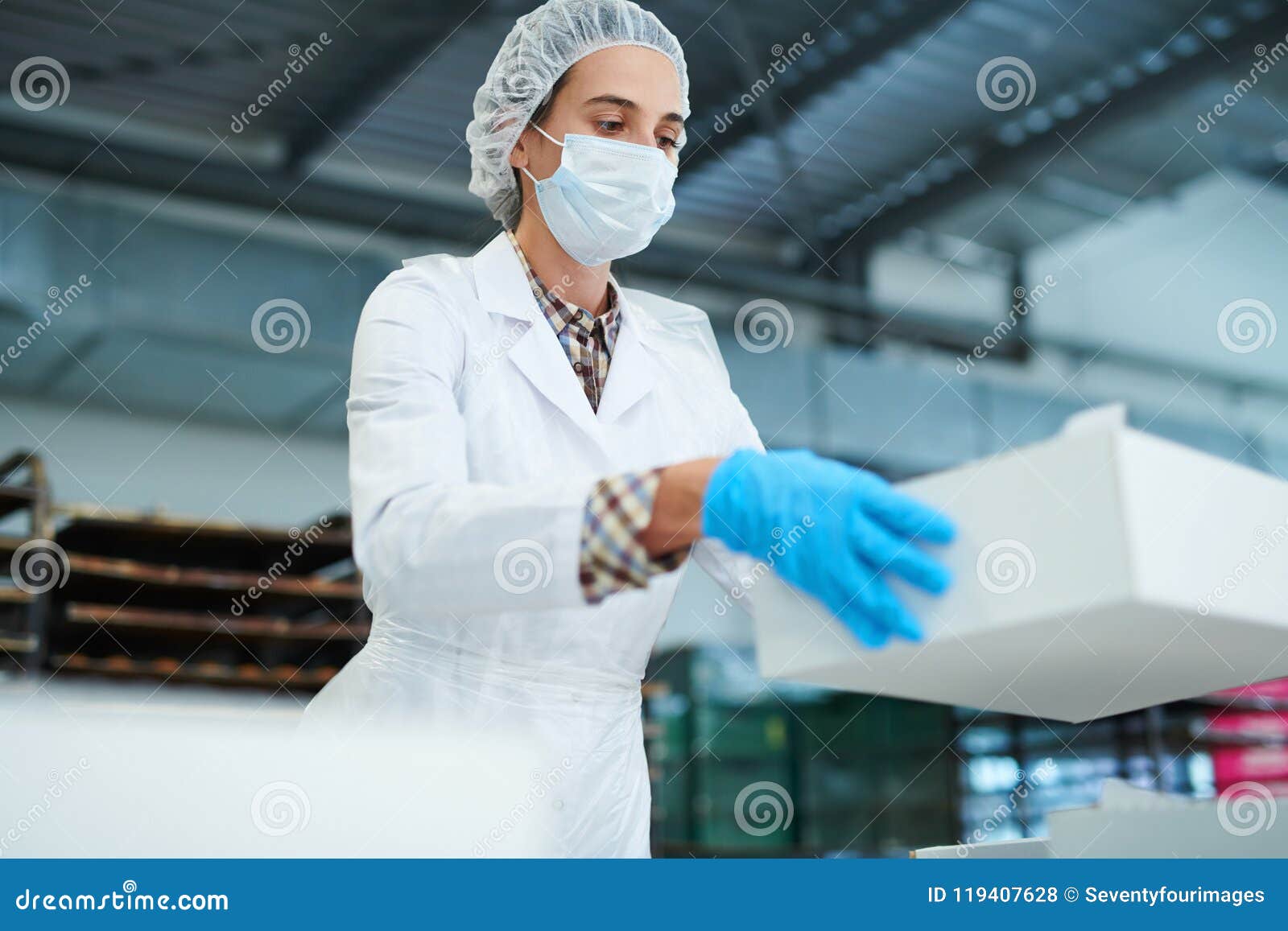 confectionery factory worker holding paper box