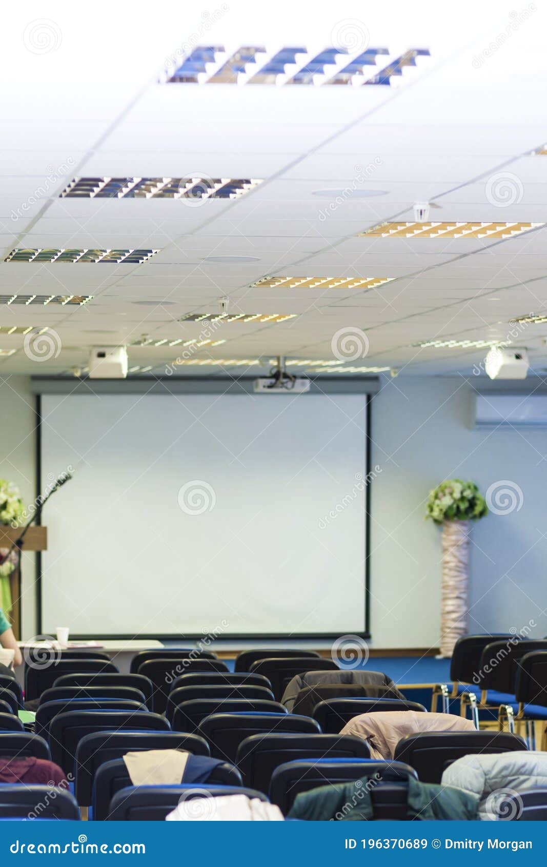 Conference Hall with Chairs in Front of Stage with Screen Stock Image