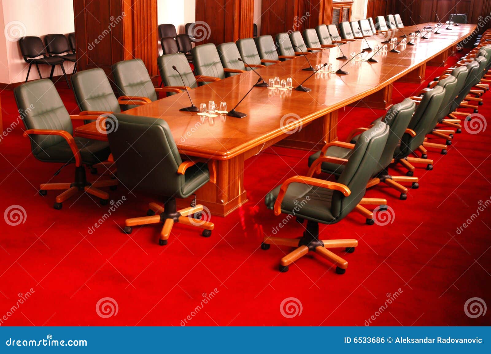 Conference room with green chairs and red carpet