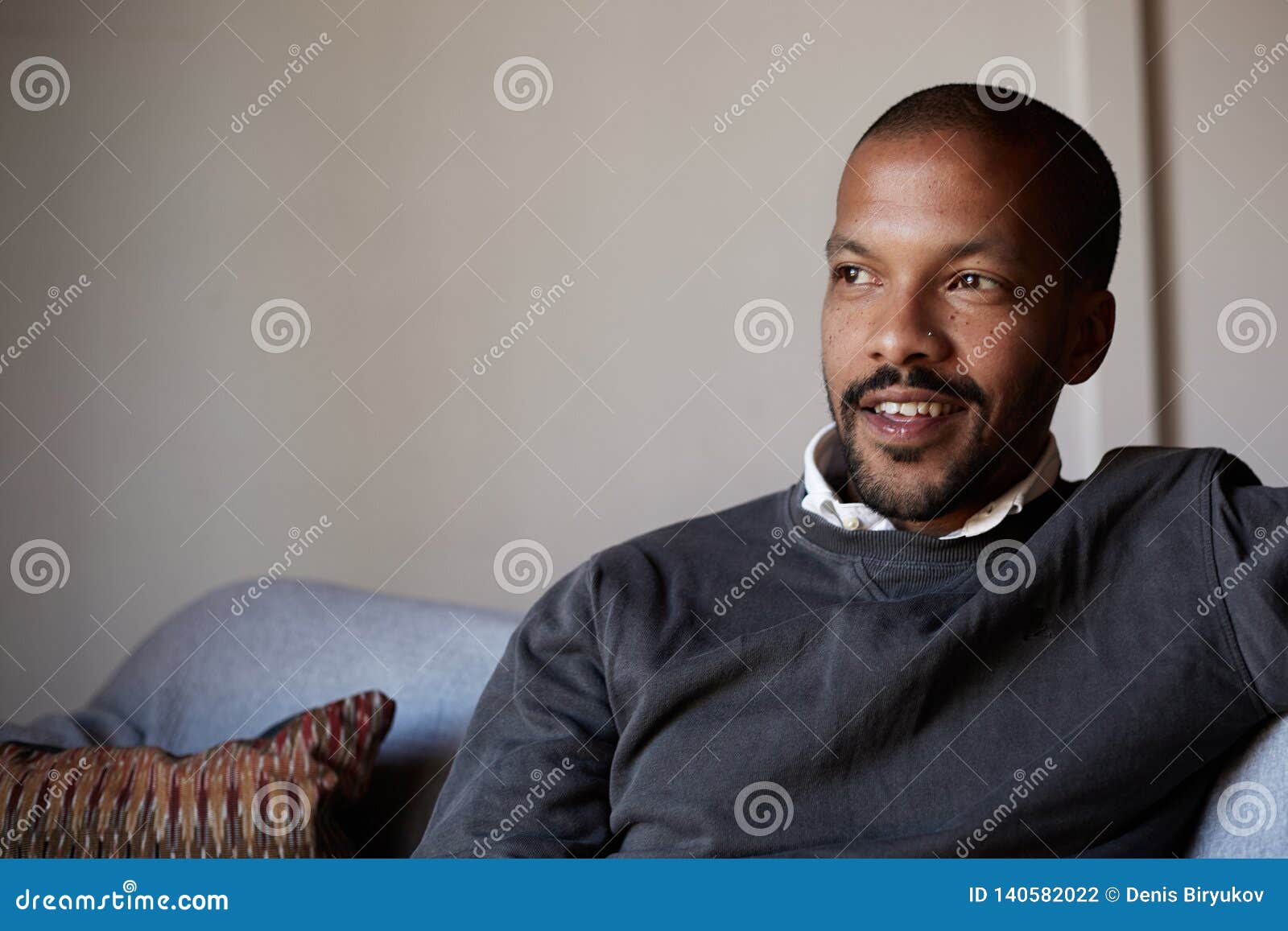 Confident African American Man Sitting on Sofa Couch at Living Room ...