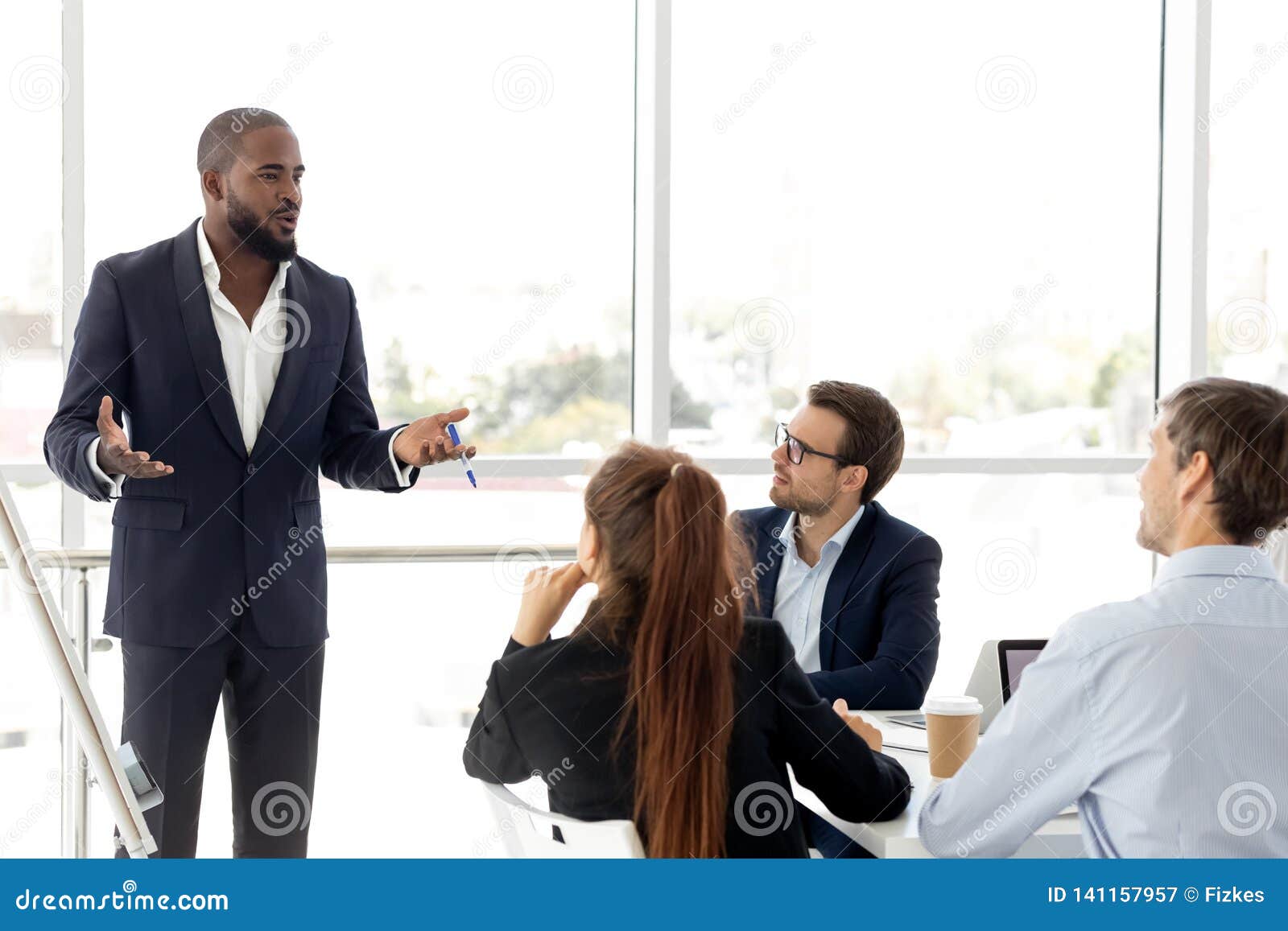 african business coach in suit giving presentation to clients