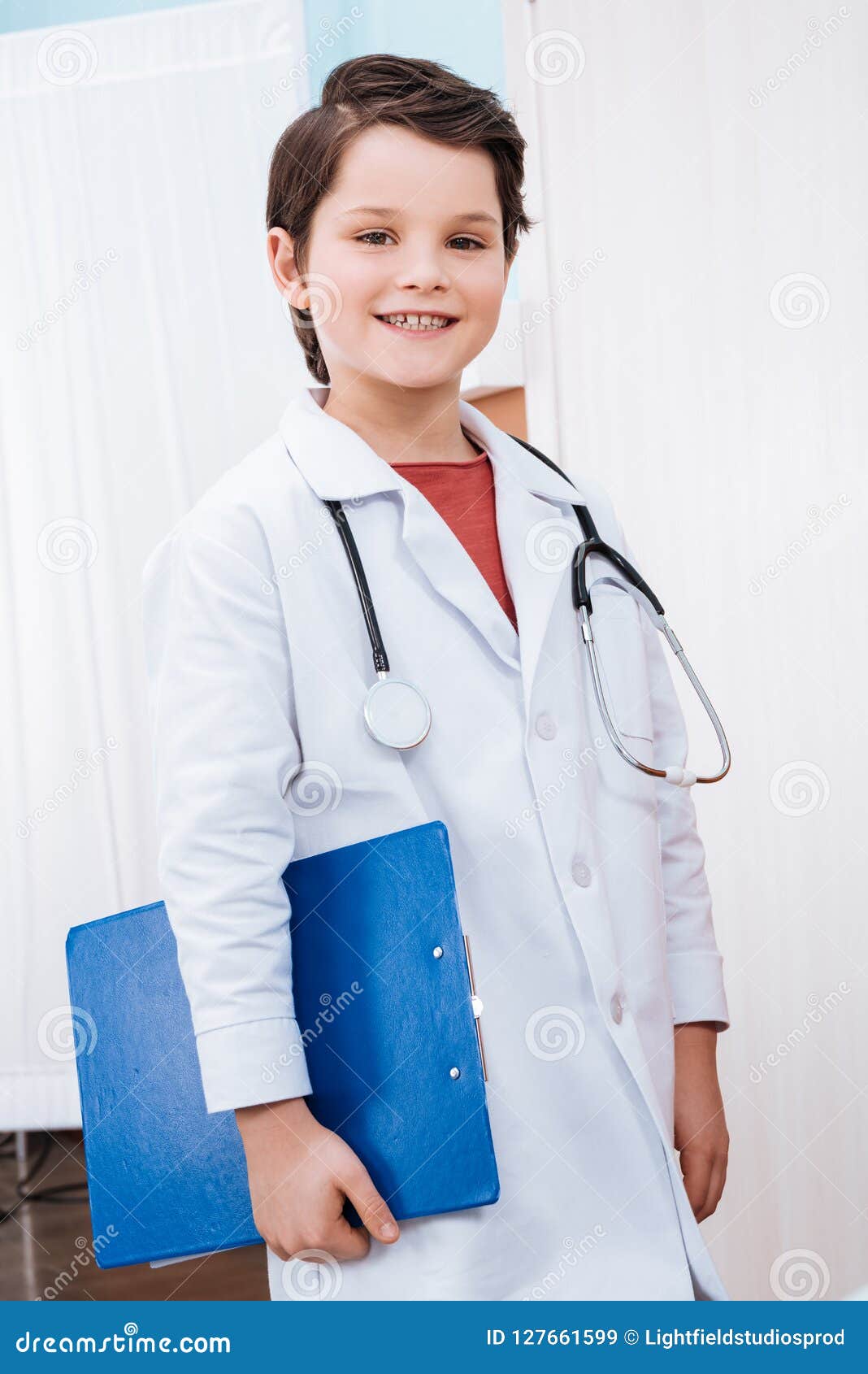 Confident Boy Doctor with Stethoscope Holding Folder and Smiling Stock