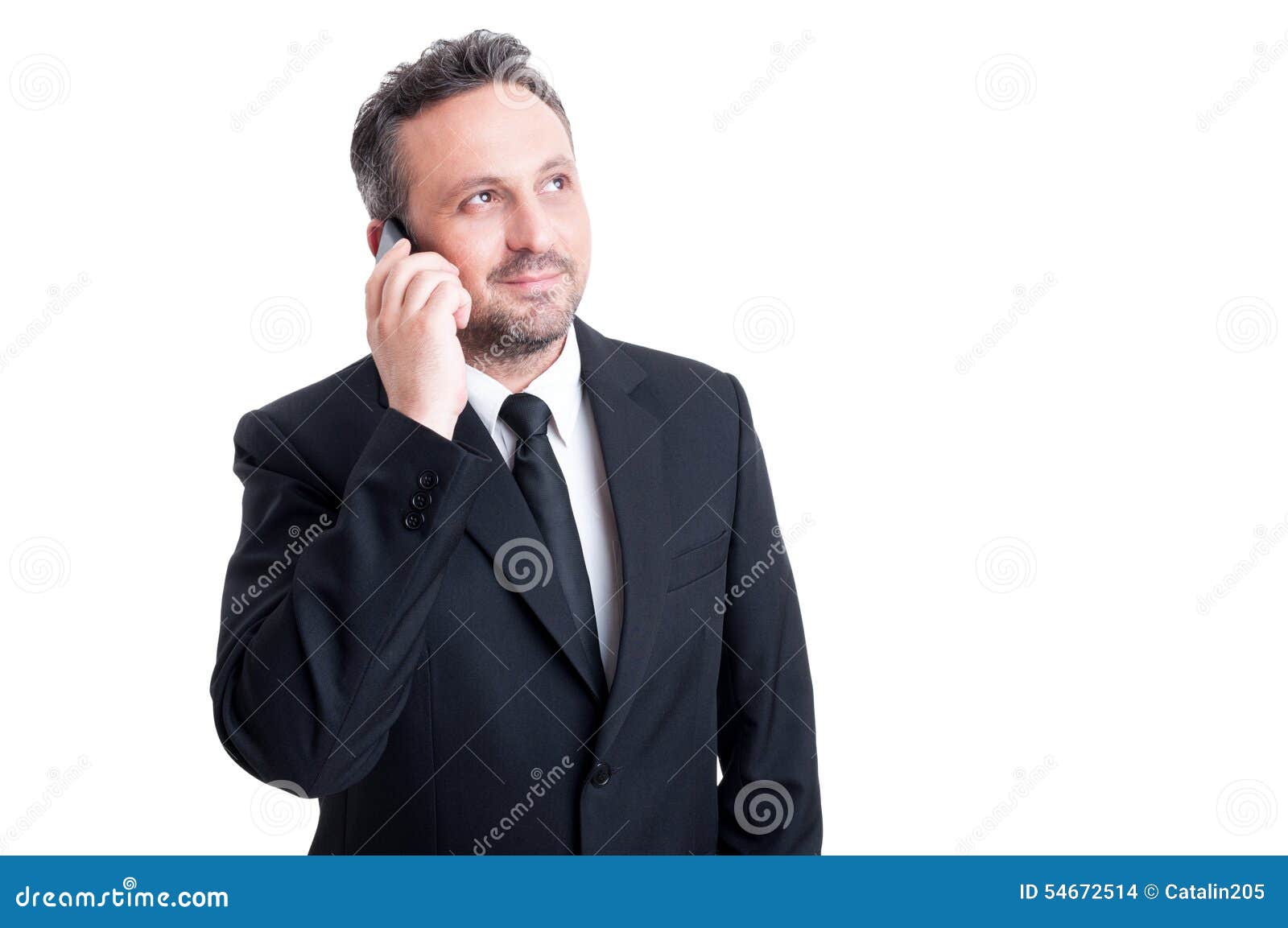 Confident business manager talking on the phone wearing black suit and tie