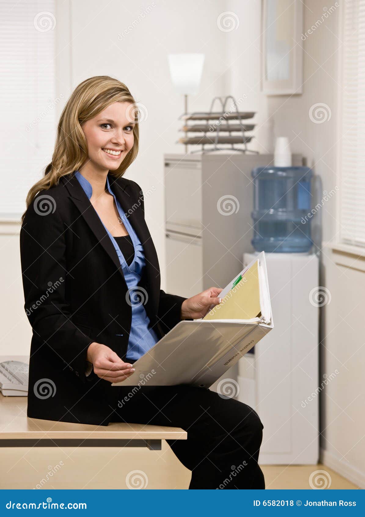 Confident business woman sitting at desk stock photo (135604