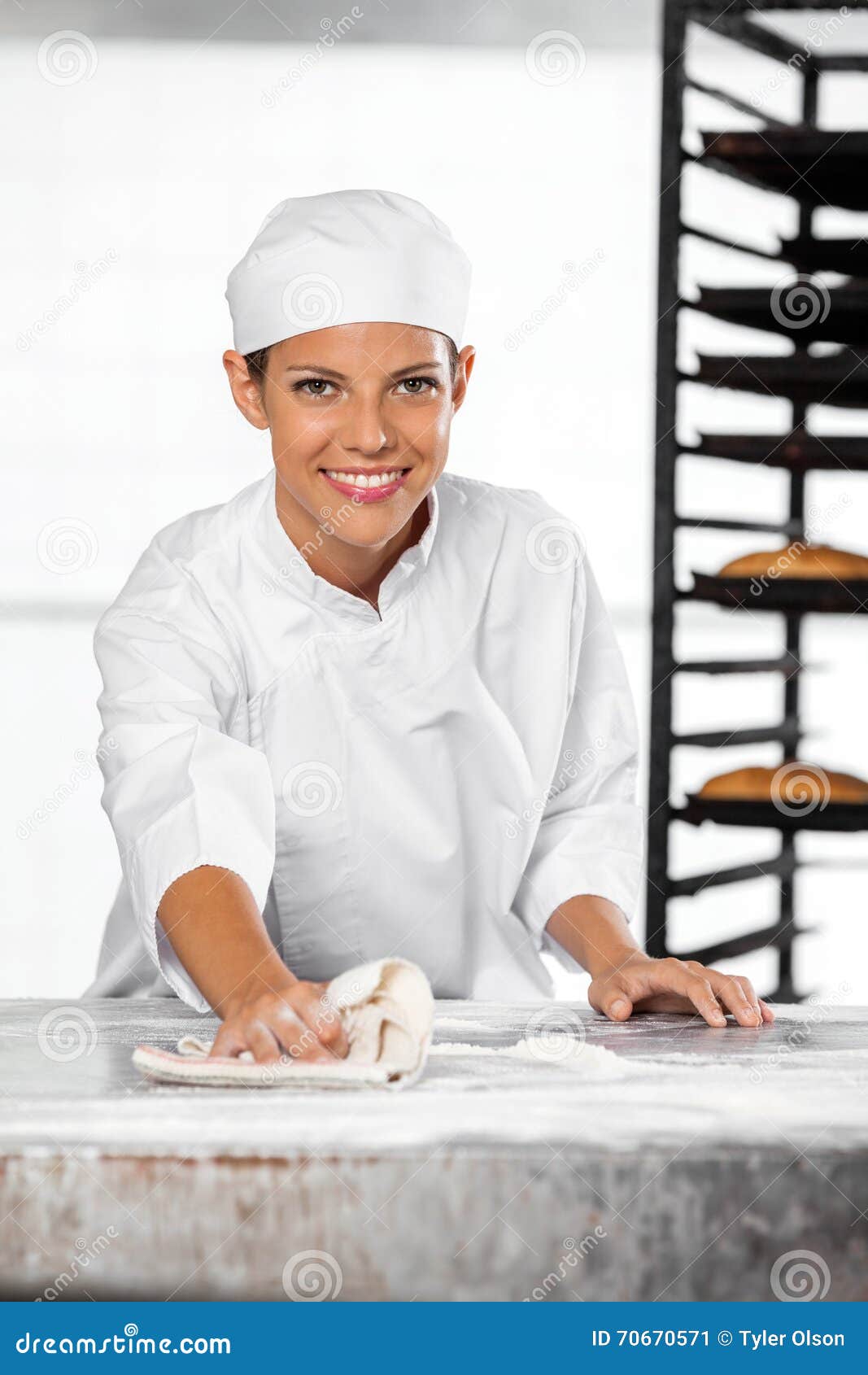 Confident Female Baker Cleaning Flour from Table Stock Image Image of