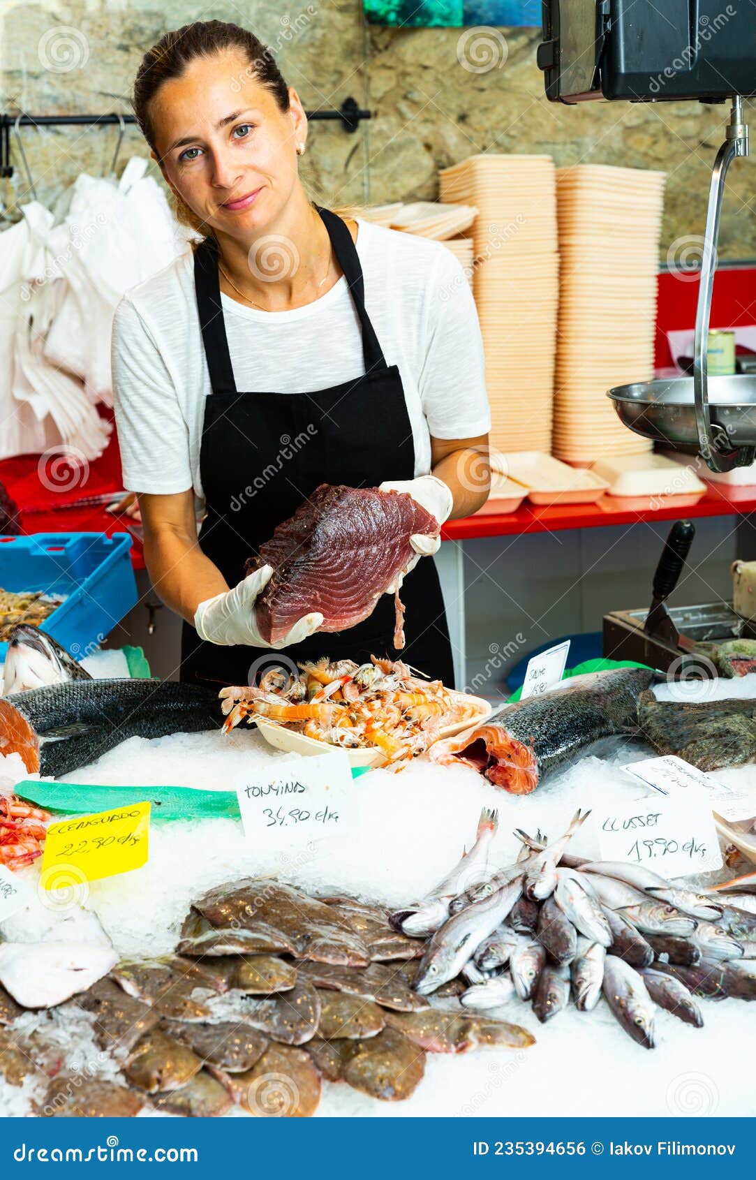 Female Fishmonger Offering Tuna Stock Photo - Image of salmon ...