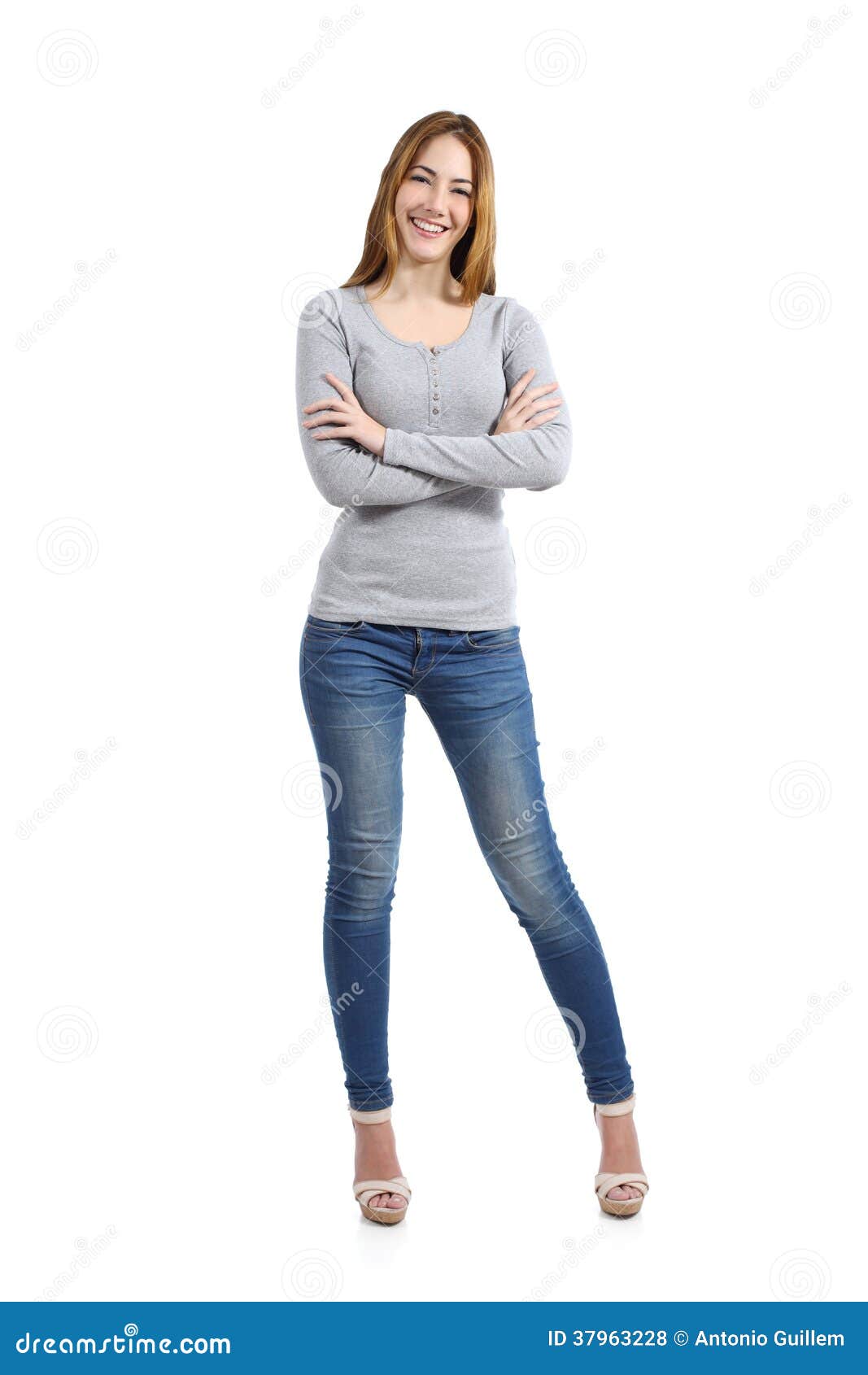 confident full body of a casual happy woman standing wearing jeans