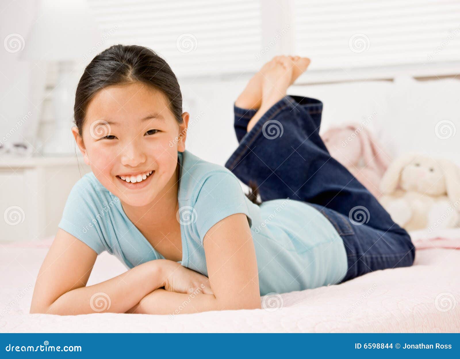 Confident Girl Laying on Bed in Bedroom Stock Photo Image of