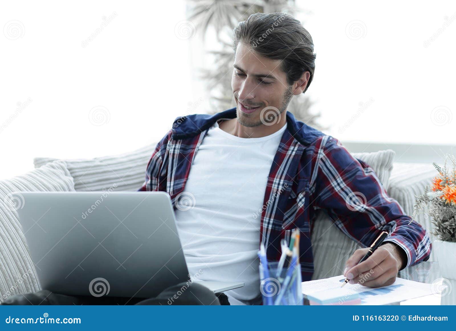 confident guy working with laptop at home.