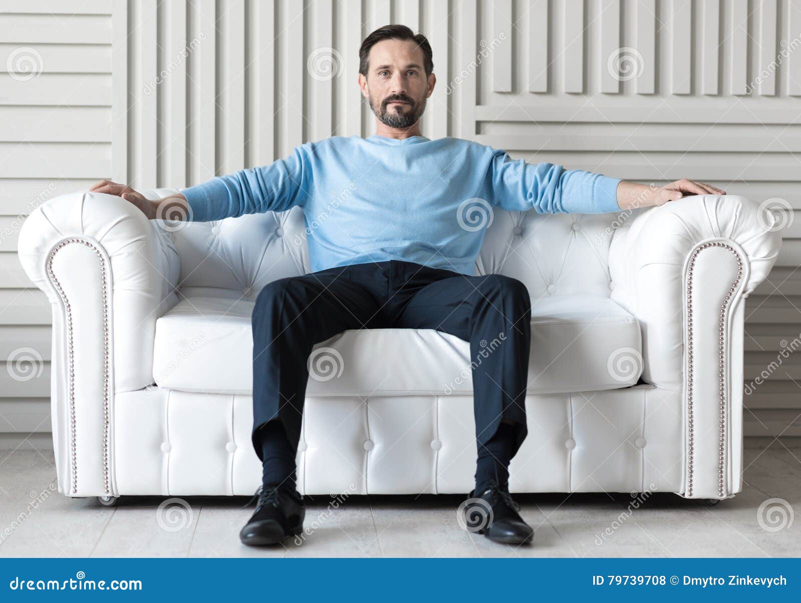 Confident Handsome Man Sitting on a Sofa Stock Photo Image of leisure