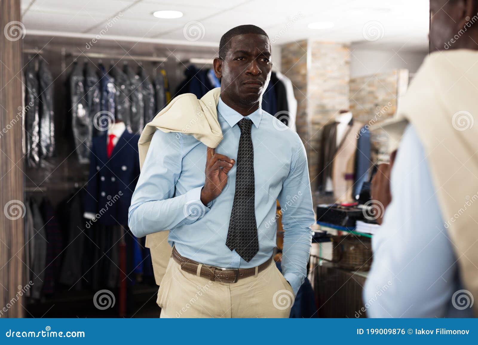 Confident Male Customer Choosing Fashion Beige Suit in Mens Store Stock ...