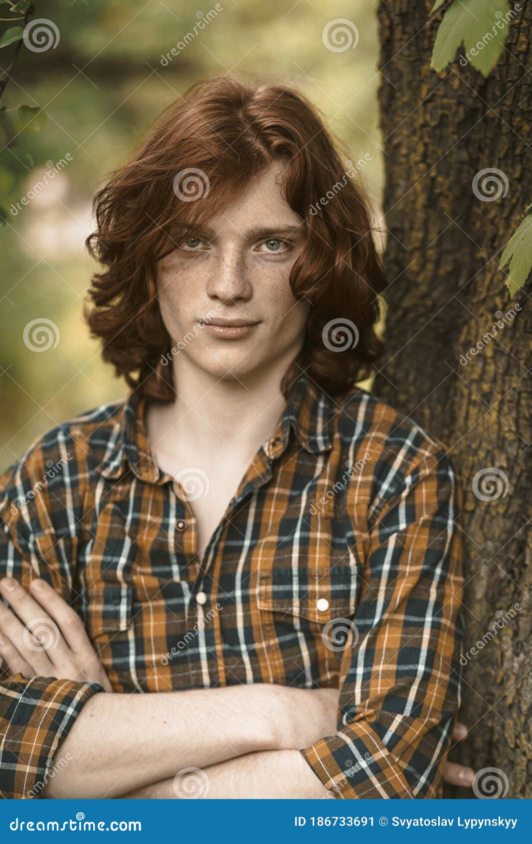 Confident Man with Long Red Hair Stands with Crossed Arms Leaning Against a  Tree Trunk. Caucasian Guy Wearing in Stock Image - Image of male,  masculine: 186733691