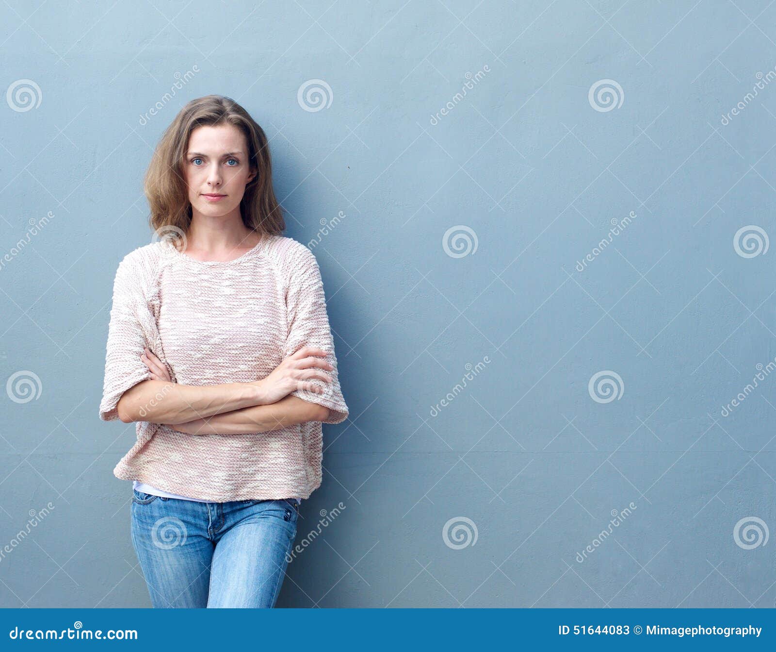 confident mid adult woman posing with arms crossed