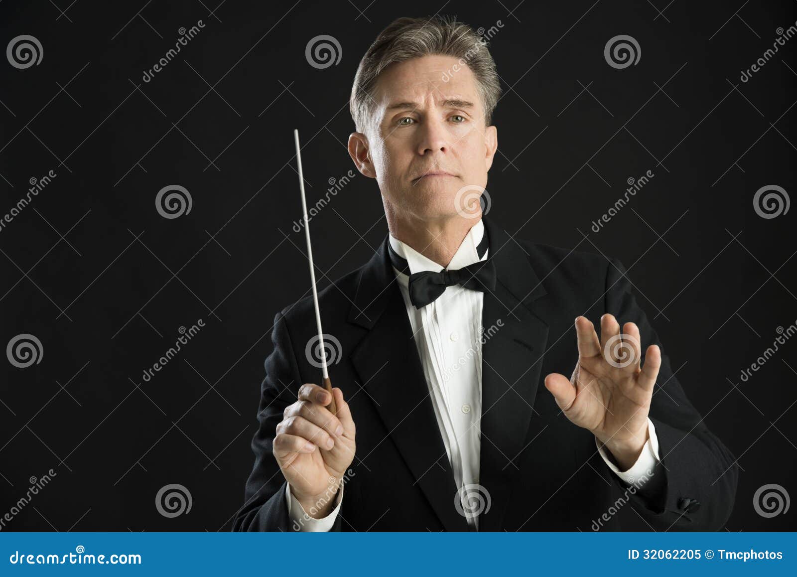 confident orchestra conductor directing with his baton