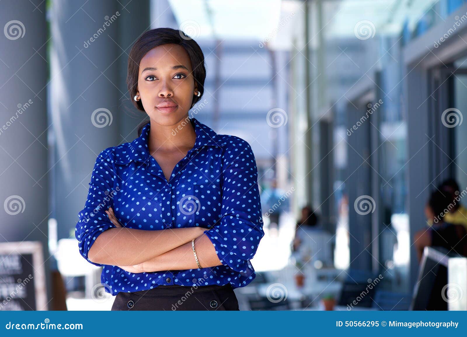 confident young african american woman standing in the city