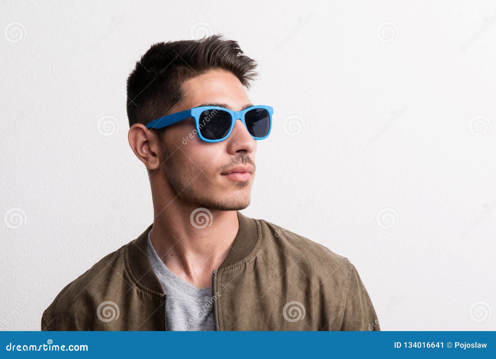 A Confident Young Hispanic Man with Sunglasses in a Studio. Stock Image ...