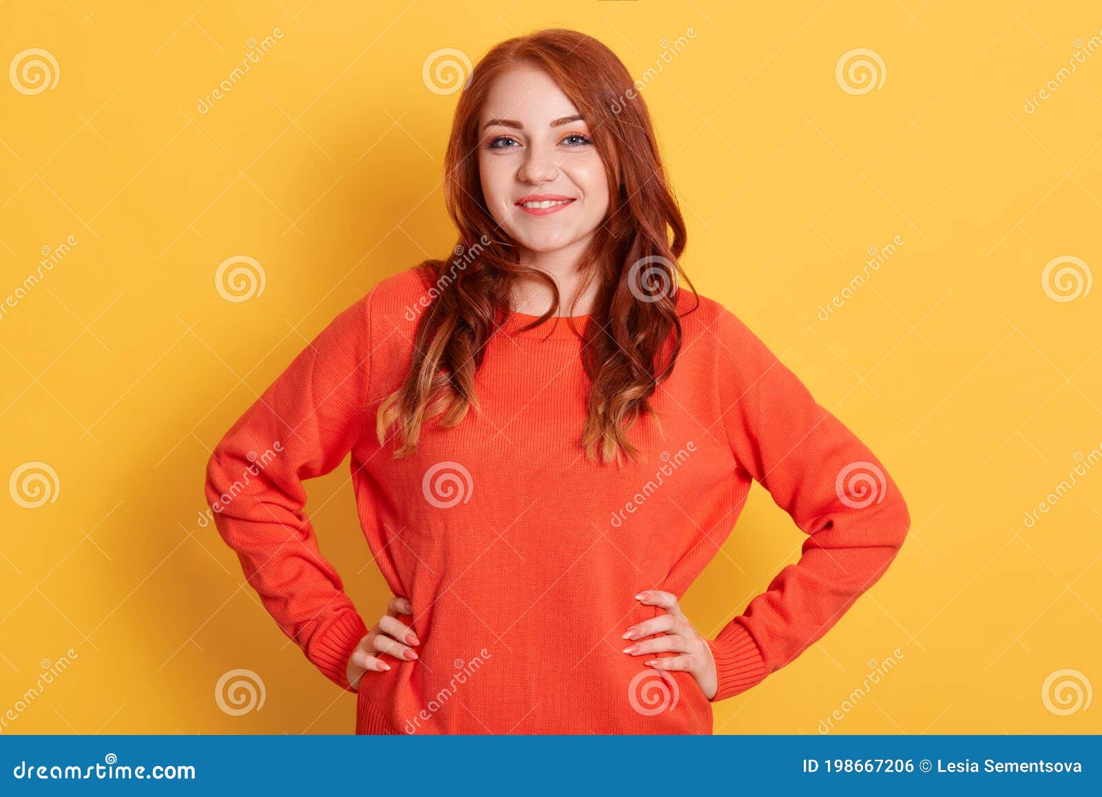 Confident Young Lady with Red Hair Standing with Hands on Hips and ...