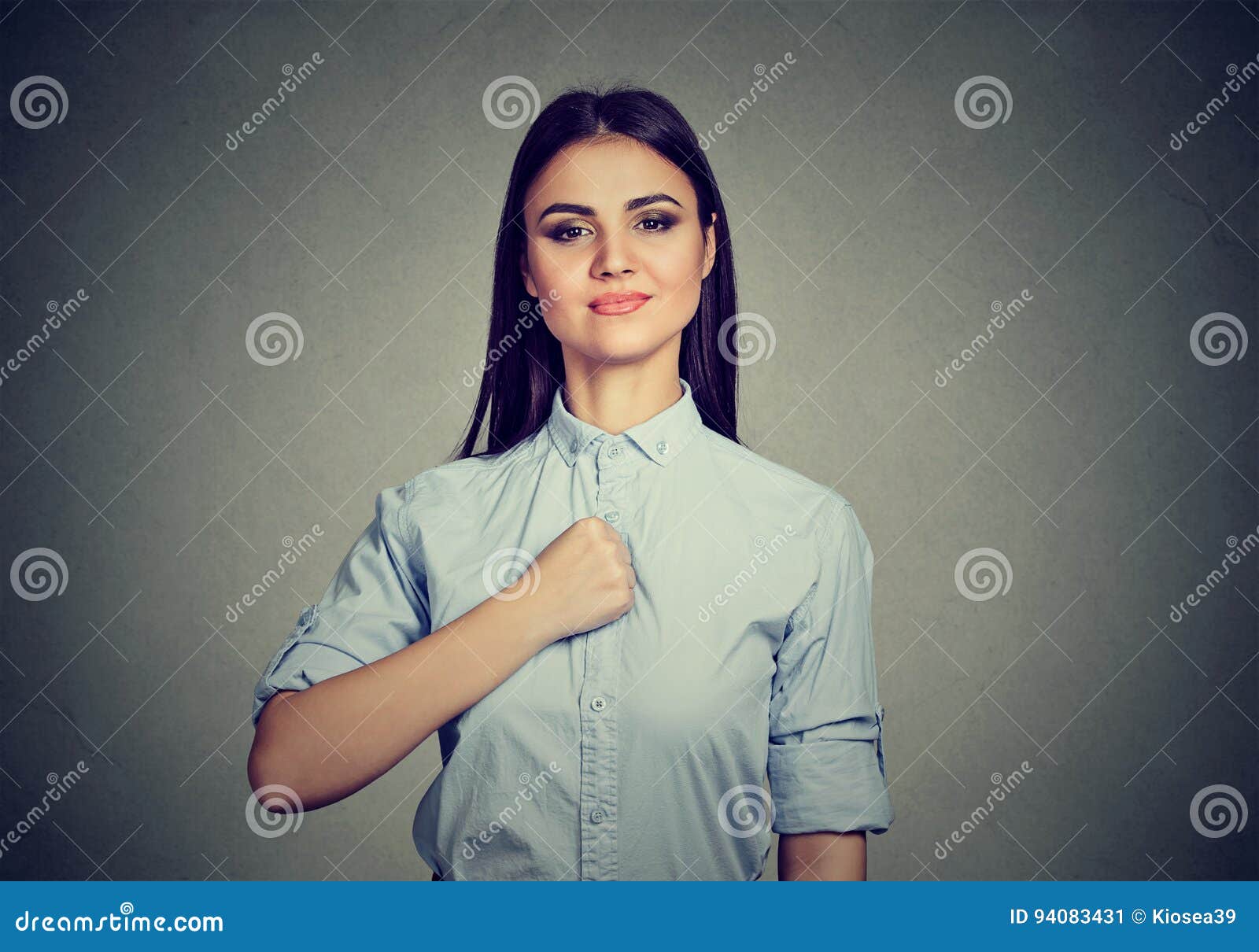 confident young woman  on gray wall background