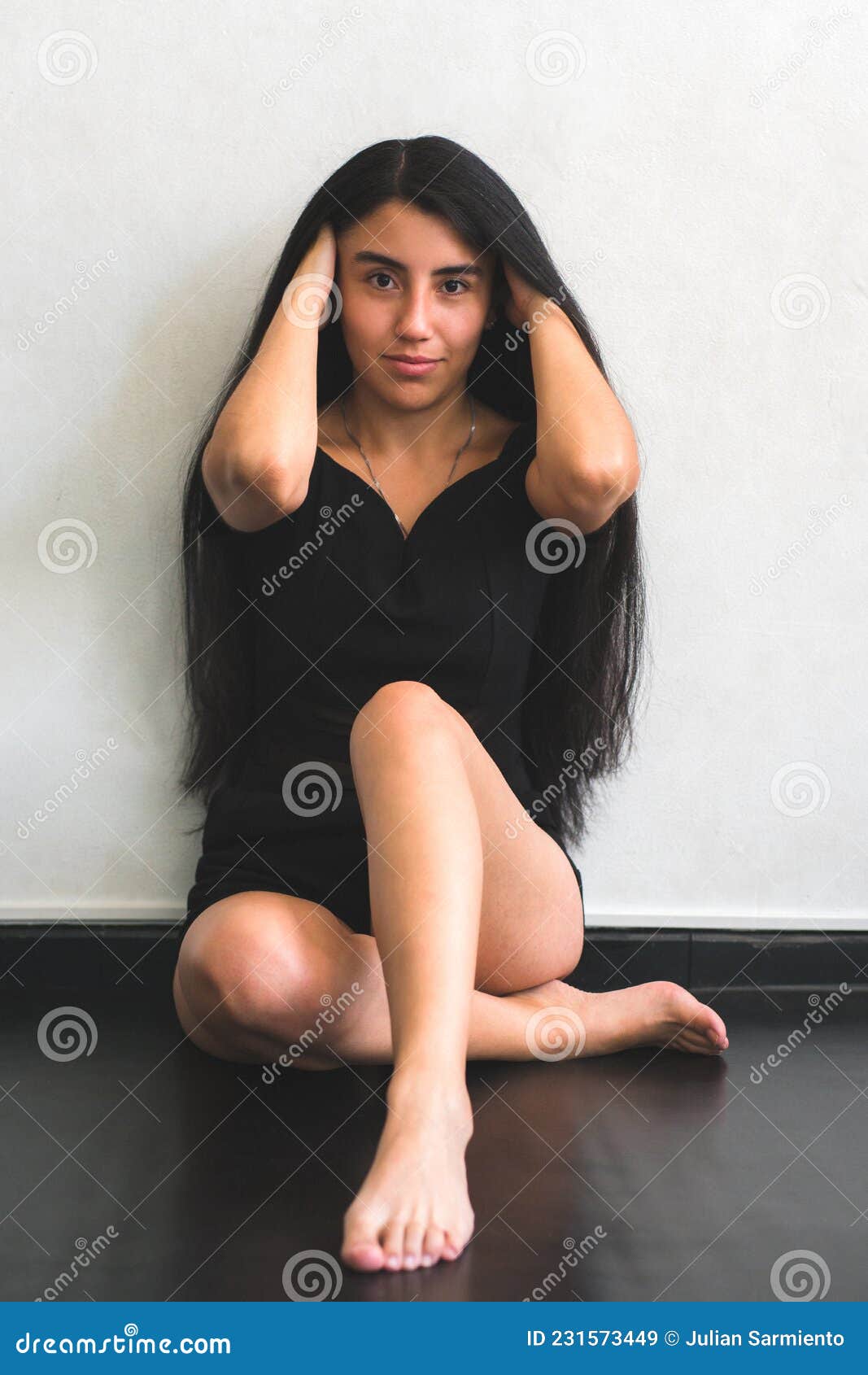 Confident Young Woman Sitting on the Floor of Her House Stock