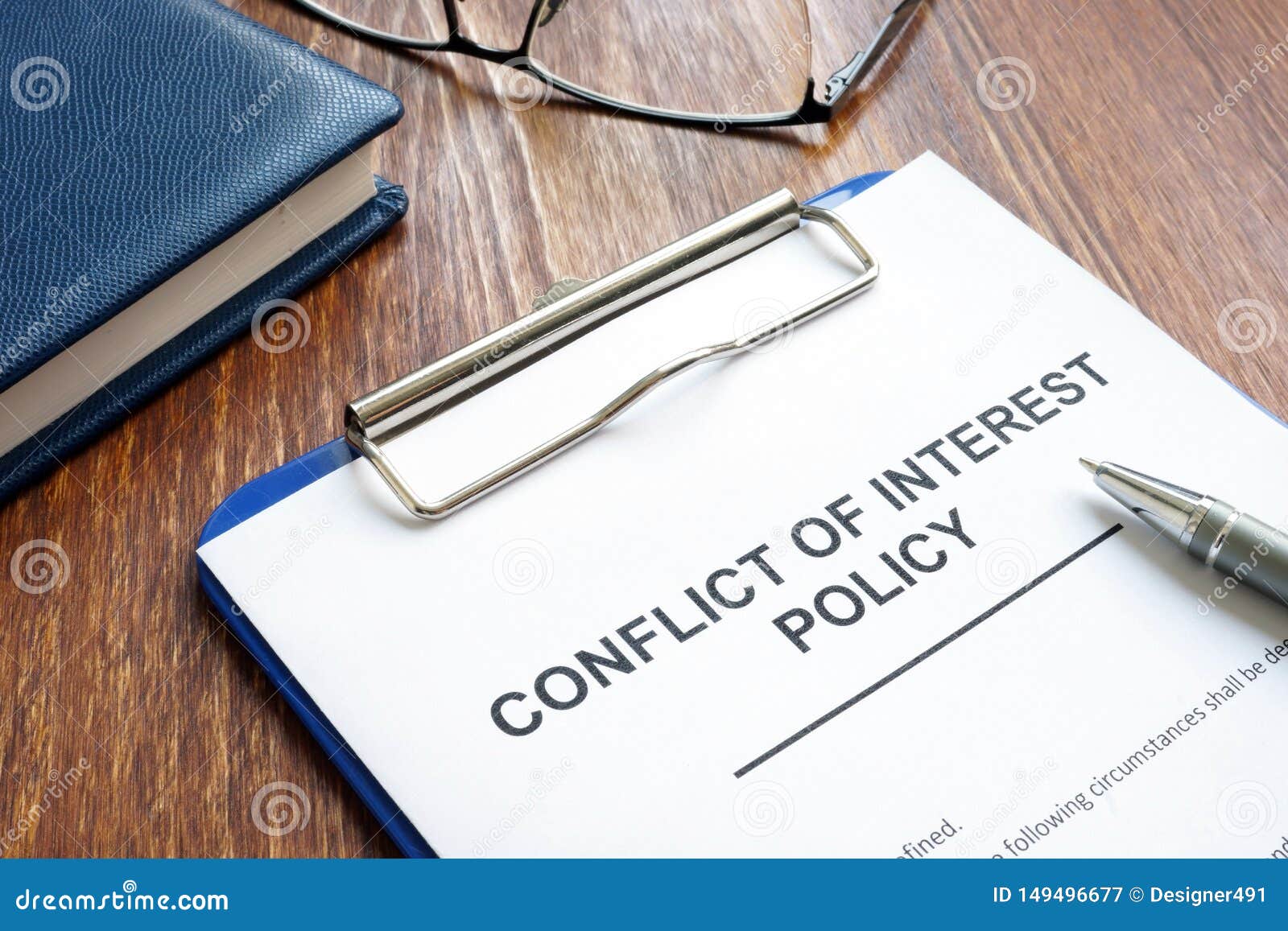 conflict of interest policy and pen on  wooden surface
