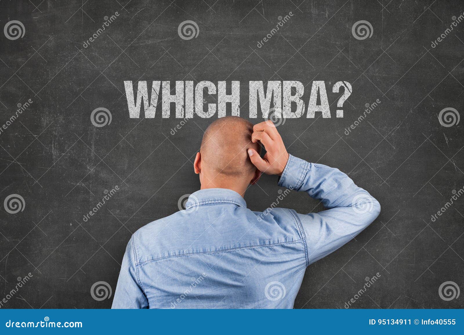 confused businessman scratching head under mba text on blackboard