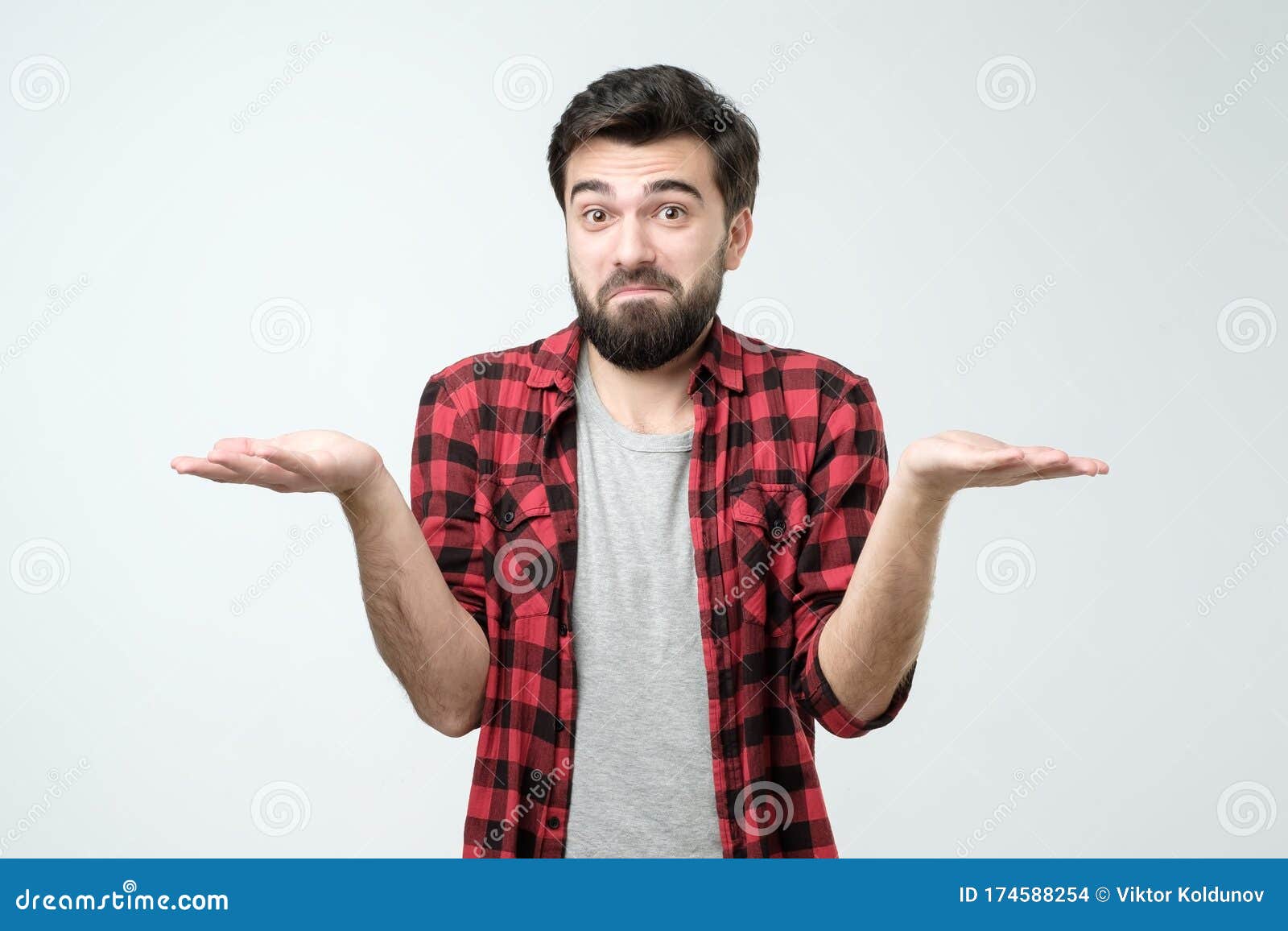 confused hispanic man giving i dont know gesture on white background.