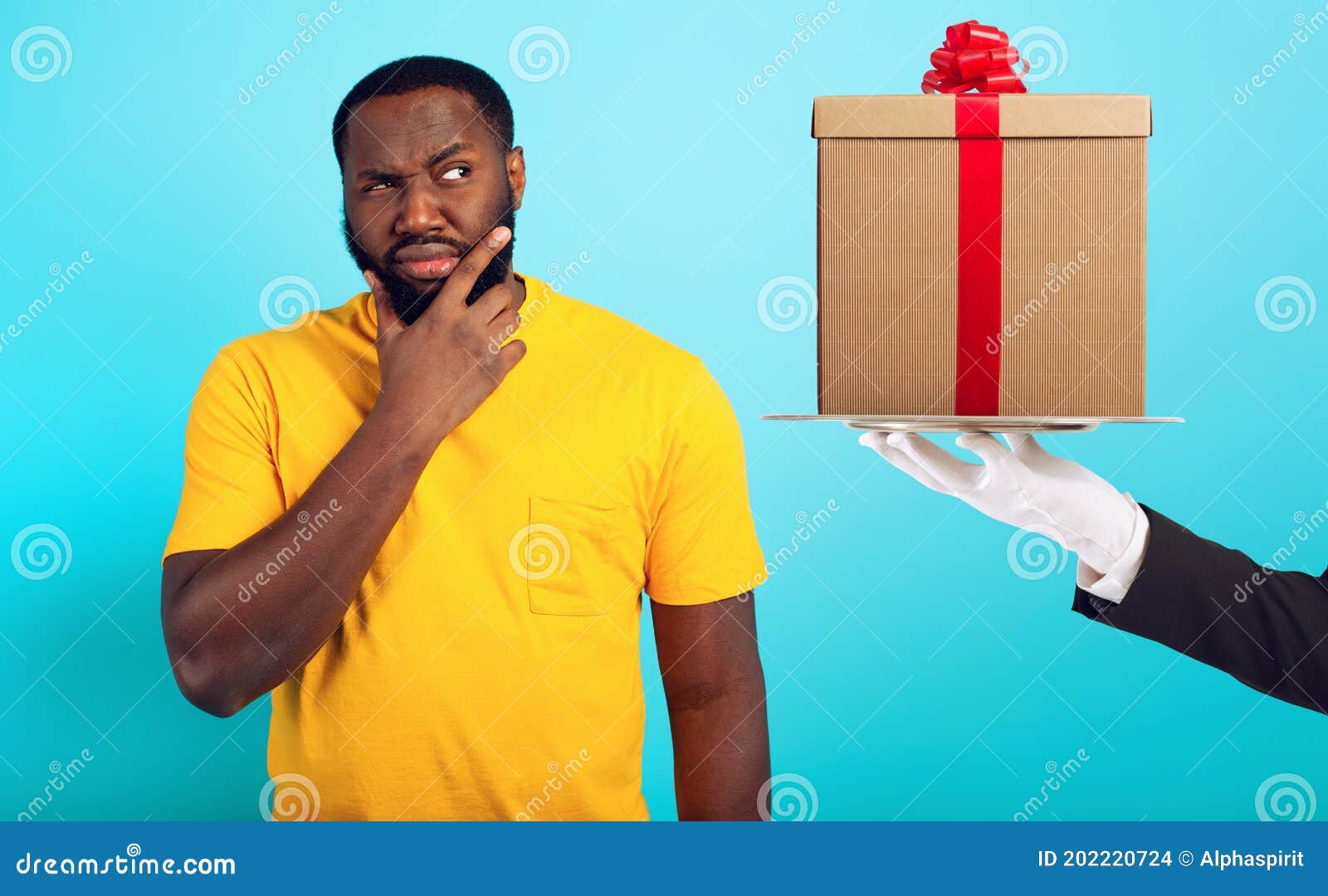 confused man is suspicious about a gift. concept of options, confusion, indecision