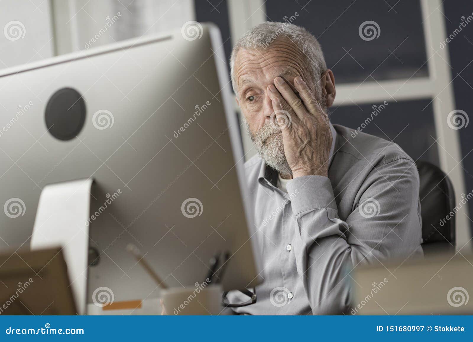 confused senior citizen using a computer