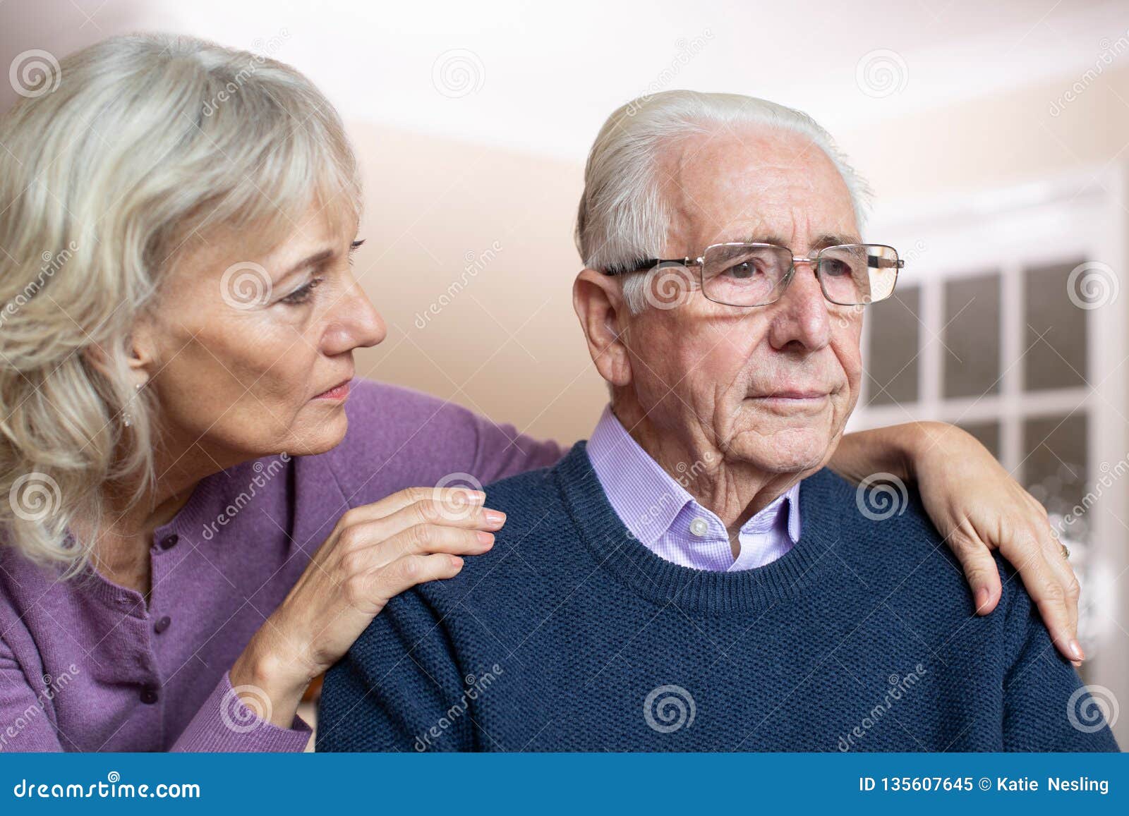 confused senior man suffering with depression and dementia being comforted by wife