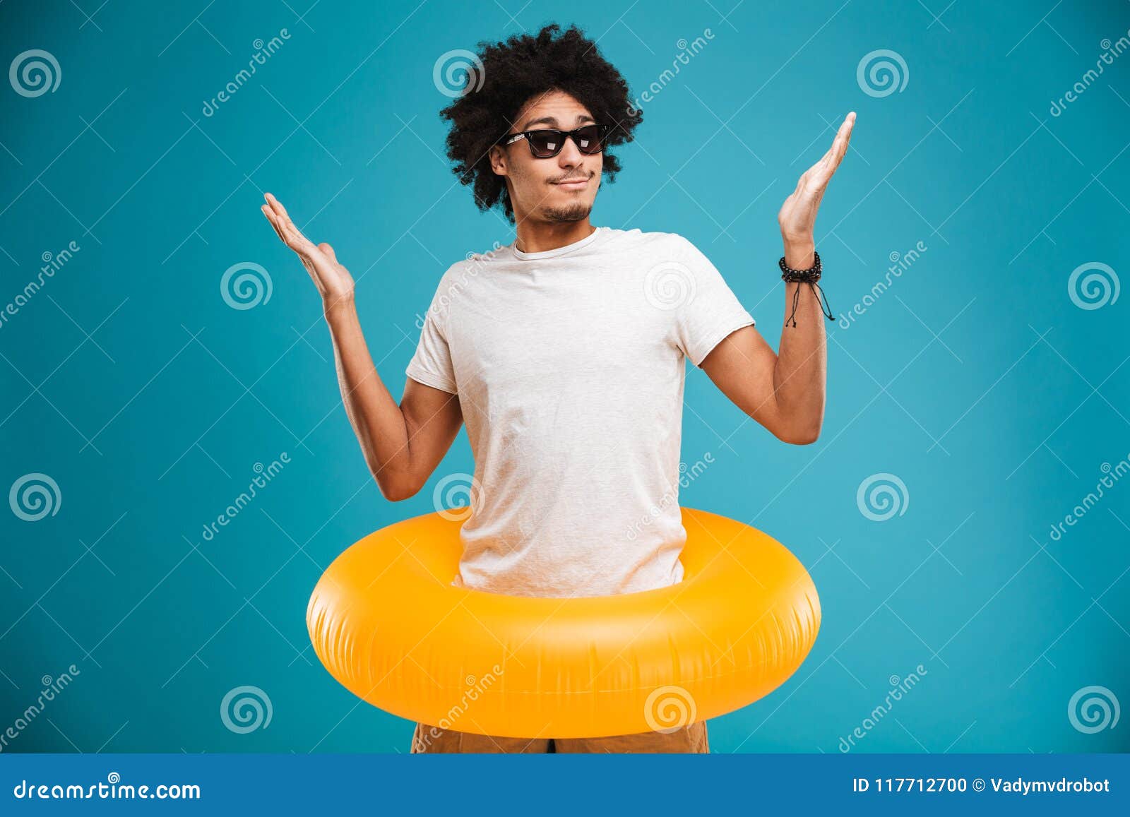 Confused Young African Curly Man Holding Rubber Ring. Stock Photo ...